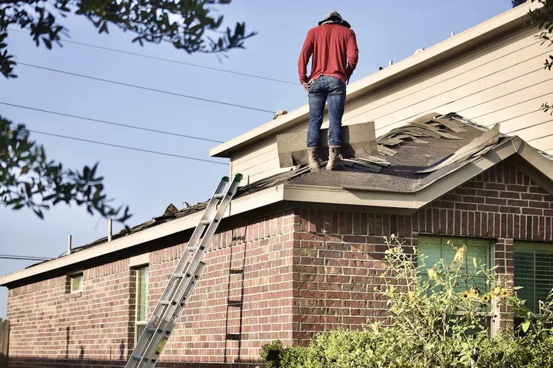 Professional roofer working on a residential roof in Homeland